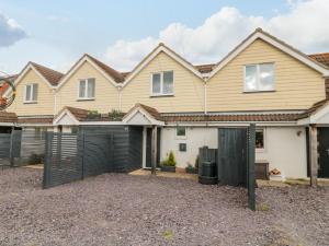 a house with a black fence in front of it at Forever Summer in Lymington