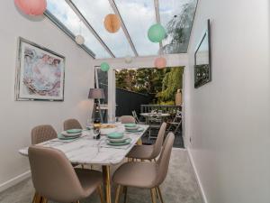 a dining room with a table and chairs at Forever Summer in Lymington