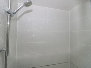 a shower stall with a shower head in a bathroom at Forever Summer in Lymington +26 photos