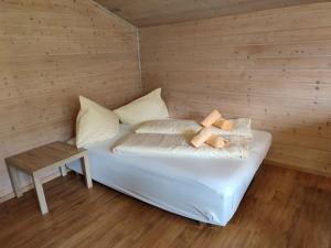 a bed in a wooden room with a table on it at Huberhof 9 by Alpenidyll Apartments in Schladming