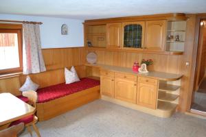 a small room with a bench in a kitchen at Ferienhaus Obersäuling in Stummerberg +9 photos