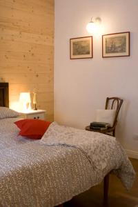 a bedroom with a bed and a lamp and a chair at My Heart in Argegno - by My Home In Como in Argegno