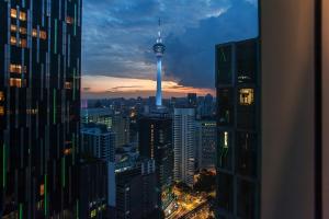 a view of a city skyline at night with the space needle at Soho Suites KLCC by Leala in Kuala Lumpur