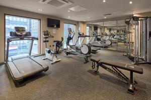 a gym with several treadmills and machines in a room at Maldron Hotel Manchester City Centre in Manchester