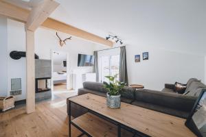 a living room with a couch and a table at M1 - Mountain Living in Rauris