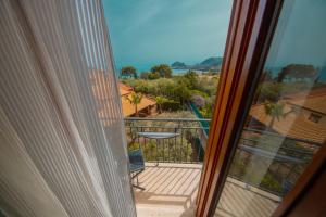 a view from a window of a balcony at Hotel Baia Del Capitano in Cefalù