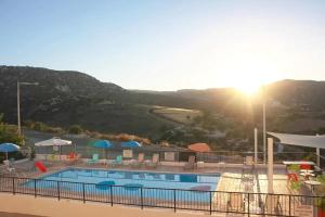 a view of a swimming pool with mountains in the background at Panoramic Holidays - Deluxe 5 in Peyia