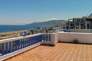 a balcony with a view of the ocean and buildings at Oued Laou - Ground Floor in Oued Laou