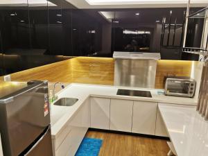 a white kitchen with a sink and a microwave at Apple Home 1 @ Menara Simfoni/Symphony Tower C180/Cheras/Mines/Balakong/Kuala Lumpur in Seri Kembangan