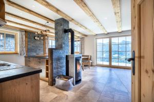 a kitchen with a stone fireplace in the middle of a room at Almliesl STJO-658 in Sankt Johann im Pongau