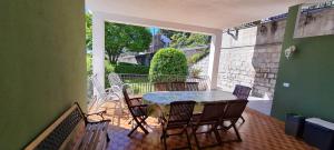a patio with a table and chairs on a balcony at APPARTAMENTO BELVEDERE 3 in Stresa