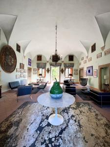 a large living room with a large green vase on a table at Villa Sardi Luxury House in Lucca