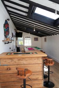 a bar in a room with two stools at Yetland Farm Holiday Cottages in Combe Martin