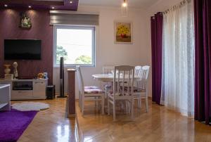 a kitchen and dining room with a table and chairs at Gazdinstvo Tadić in Nikšić