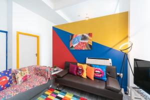 a living room with a couch and a colorful wall at Stylish Stunning City Centre Jesouth Boutique Pad in Hull