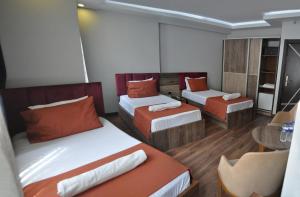 Habitación con 2 camas y mesa con mesa. en Waha Hotel en Bursa