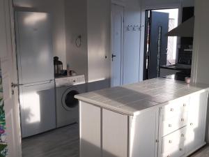 a kitchen with a counter and a washing machine at Solstua in Sandefjord