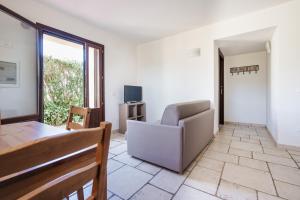 a living room with a couch and a table at Agriturismo Ristorante Monte Argentario in Monte Argentario