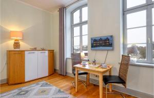 a living room with a table and chairs and windows at Gorgeous Apartment In Krakow Am See With Wifi in Krakow am See