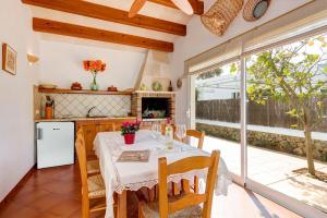 a kitchen and dining room with a table and chairs at Villa Maggie by Villa Plus in Cala en Blanes
