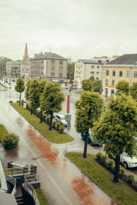 a view of a city street in the rain at 2 bedroom central flat in Jelgava