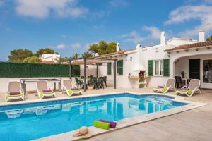 a villa with a swimming pool and a house at Villa Isi by Villa Plus in Cala en Blanes