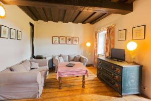 a living room with a couch and a tv at Gärtnerhaus in Steinakirchen am Forst