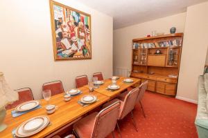 a dining room with a long table and chairs at Barton House in Woolacombe