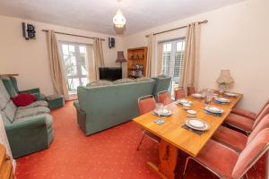 a living room with a wooden table and chairs at Barton House in Woolacombe