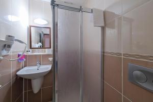 a bathroom with a sink and a glass shower at Casablanca Hotel in Dalyan