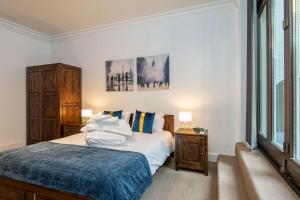 a bedroom with a bed and two windows at Apartment 3, 48 Bishopsgate by City Living London in London