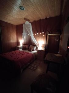 a bedroom with a bed in a wooden room at Herdade da Hera in Azambuja