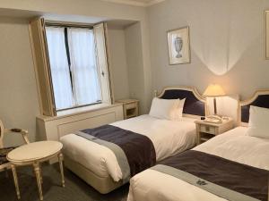 Postel nebo postele na pokoji v ubytování Hotel Monterey Osaka