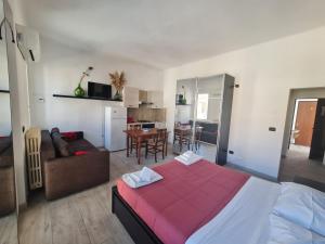 a bedroom with a large bed and a living room at Dormi da me sul mare in Civitanova Marche