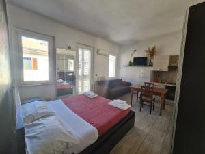 a bedroom with a large bed and a dining room at Dormi da me sul mare in Civitanova Marche