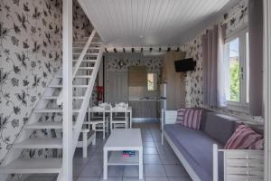 a living room with a staircase and a couch at Potamaki Studios & Apartments in Stoupa