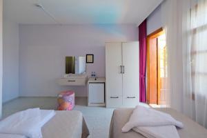 a white bedroom with a bed and a bathroom at Casablanca Hotel in Dalyan