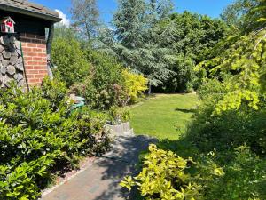 a garden with a brick house with a pathway at Ferienhaus Krakow am See in Krakow am See