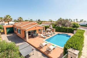 an aerial view of a house with a swimming pool at Villa Violeta by Villa Plus in Cala en Bosc