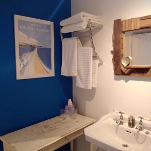 a bathroom with a sink and a mirror at The Artist's Retreat in Calstock