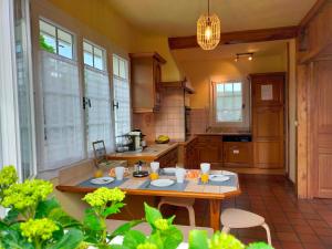 eine Küche mit einem Tisch in der Mitte in der Unterkunft Maison 110 m² cosy au calme avec jardin de 1000 m² in Pont-Audemer