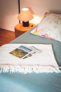 a magazine sitting on top of a bed at Gîte La Source in Grusse