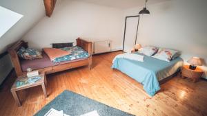 a bedroom with a bed and a couch and a table at Gîte La Source in Grusse