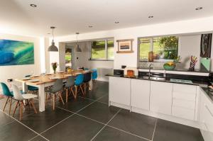 a kitchen and dining room with a table and chairs at Coastal Retreat in Woolacombe +13 photos