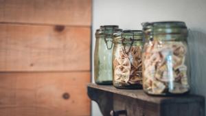 three jars filled with food on top of a table at Gîte La Source in Grusse