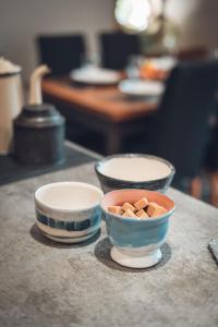 three bowls of food sitting on a counter at Gîte La Source in Grusse