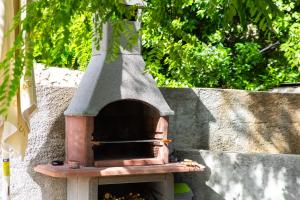 a small brick oven sitting on top of a wall at Cute & Green in Opatija