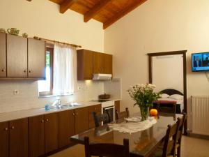 a kitchen with a table and a dining room at Villa Internity in Alikampos +49 photos