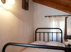 a metal bed in a room with a window at Villa Internity in Alikampos