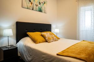 フゼタにあるCasa Terraçoのベッドルーム1室(大型ベッド1台、黄色い枕2つ付)